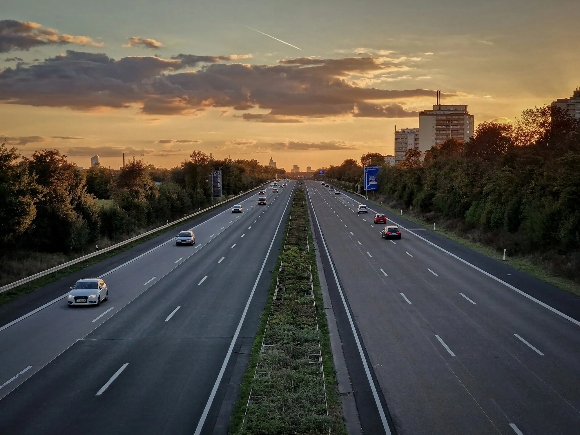 Divided highway at sunset with light traffic